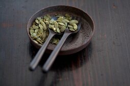 Pumpkin seeds and wooden spoons