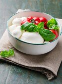 A bowl of tomatoes, mozzarella and basil