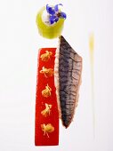Smoked mackerel fillet with pepper jelly and small flowers and stuffed cucumber rolls with chervil flowers
