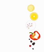 Slices of citrus fruits, pills, a red pepper and berries on a white surface