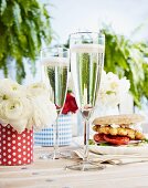 Champagne and burgers made with grilled unleavened bread in the background