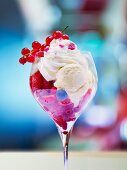 An ice cream sundae with fresh berries and cream
