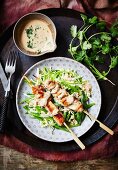 Vegetables salad with chicken satay kebabs (Asia)