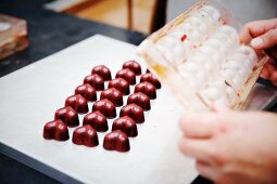 Heart-shaped chocolate pralines in a chocolate factory
