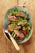 Lamb fillet with green beans, olives and tomatoes
