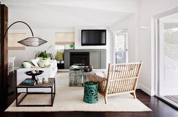 Modern living room with coffee table, fireplace, rustic, slatted, wooden chair and large terrace windows