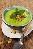 Pea soup with croutons and mint
