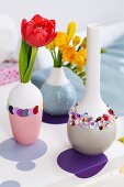Tulips and freesias in vases decorated with confetti