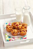 Strawberry muesli muffins and milk on a tray