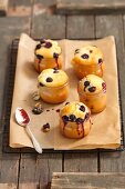 Blueberry muffins baked in glasses on a piece of baking paper