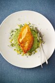 Baked salmon fillet with a horseradish coating on a bed of herb cream