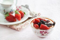Porridge with berries in a floral coffee cup