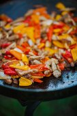 Fried pork with onions and peppers for fajitas