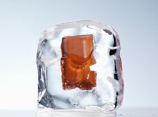 A piece of chocolate in an ice cube