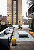 Spacious seating area with designer furniture on loft terrace; view of high-rise cityscape in Johannesburg, South Africa