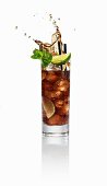 A Cuba Libre splashing out of the glass