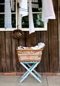 Laundry basket on folding stool outside rustic wooden cabin