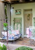 Vintage metal couch on veranda of farm house