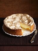 A cheesecake topped with meringue, sliced