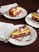 Three slices of Eierschecke (speciality layer cake from Saxony and Thuringia) with cherries