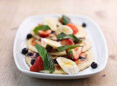 Pancakes with fruit salad and mint