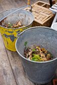 Two zinc buckets, one with peeling yellow paint