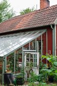 Conservatory extension on wooden cabin in garden