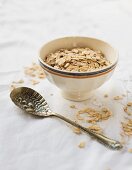A bowl of porridge oats and a vintage spoon