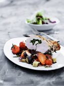 Turkey breast on a bed of summer vegetables