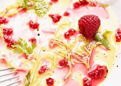 Remains of a mixed leaf salad with raspberries (close-up)