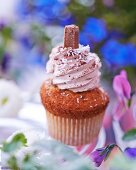 A cupcake topped with chocolate cream