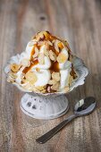 Frozen yogurt with caramel sauce and slivered almonds
