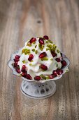 Frozen yogurt with chopped pistachios and pomegranate seeds