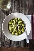 Gnocchi with green pesto and grated Parmesan