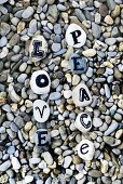 Letters on pebbles spelling out 'Love' on gravel surface