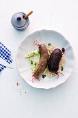 Black pudding and liver sausage with sauerkraut and mashed potatoes