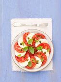 Tomatoes with mozzarella, capers and basil