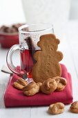 Mulled wine, gingerbread and Christmas biscuits with cashew nuts on a red cloth