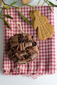Spice bauble and almond biscuit on gingham cloth