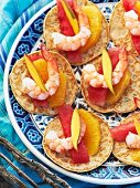 Mini blinis with orange, watermelon and prawns