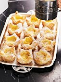 Flaky pastries with vanilla cream and icing sugar