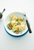 Fried ravioli with pesto and rocket