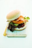 A burger with baked Camembert, cranberries and bacon