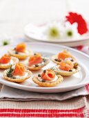 Tartlets topped with smoked salmon, creme fraiche and capers