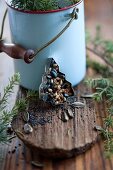 Pastry cutter filled with bird food in front of enamel pot