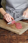 Beef fillet being sliced for carpaccio