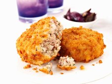 Breaded sausage meat patties with onions