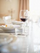 A Thanksgiving place setting with a glass of water and a glass of red wine