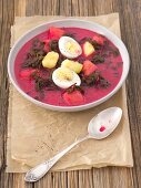 Beetroot soup made from roots and leaves with fried potatoes and egg