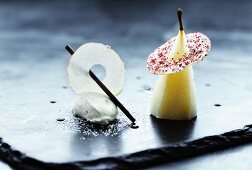 A pear poached in white wine with apple ice cream